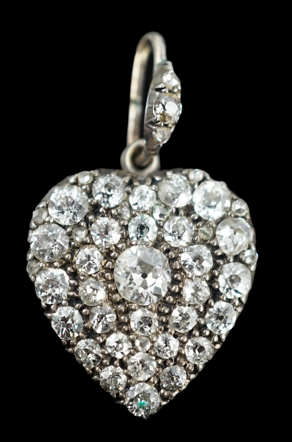 An early 20th century white gold and pave set diamond heart shaped pendant